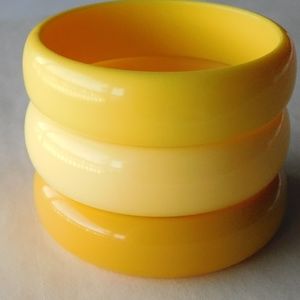 three chunky VINTAGE plastic yellow bangles